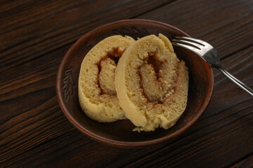 Homemade Swiss Roll Cake Slices on Rustic Wooden Table with Fork