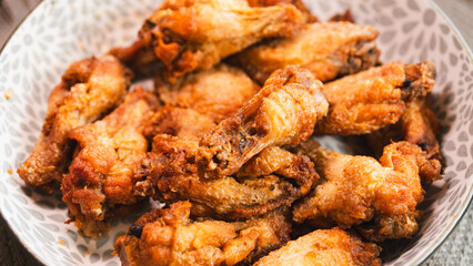 Close-up of golden-brown, crispy fried chicken served on a stylish plate. Highlights the perfect texture and seasoning. Ideal for food blogs, restaurant menus, and social media content promoting comfo