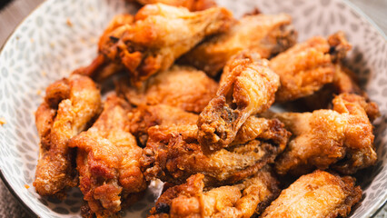 Close-up of golden-brown, crispy fried chicken served on a stylish plate. Highlights the perfect texture and seasoning. Ideal for food blogs, restaurant menus, and social media content promoting comfo
