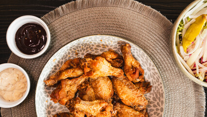 Golden-brown crispy fried chicken served with a fresh side salad bowl and creamy dipping sauce. Perfectly styled for food photography, highlighting texture and balance. Ideal for menus, blogs, and soc
