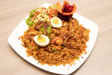 Biryani Platter with Egg, Meat, Shrimp and Salad in plate side view of bangladeshi food