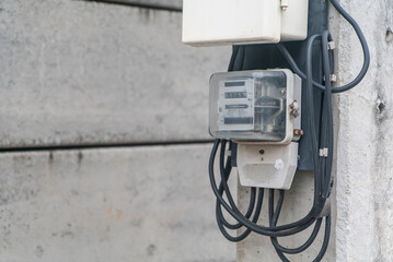 Electric Meter on Gray Concrete Wall