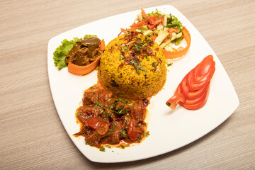 Beef Khichuri with Spicy Curry, Salad, and Pickled Chili Platter side view of bangladeshi food