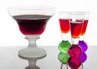 Alcohol punch with rum and vodka served in glasses, colourful and refreshing cocktail, perfect for bar and restaurant decoration, festive drink composition, natural light, party beverage scene.