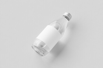Small water bottle mockup with blank label, clear glass