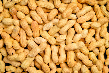 Background of nuts. Unshelled peanuts close-up. Nut texture.