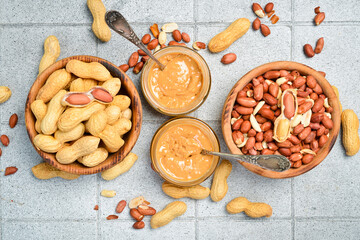 Delicious peanut butter in a glass jar. Homemade nut paste. Nuts close-up.