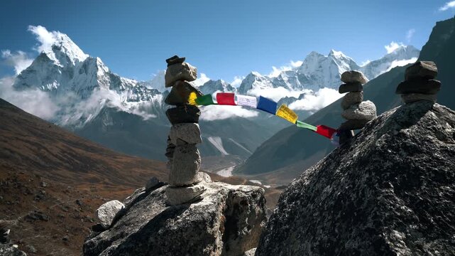 Holy Buddhist prayer flags with multicolored mantras flapping in strong wind, valley view and Ama Dablam 6812m peak. Everest Base Camp trekking route near Dughla 4620m.