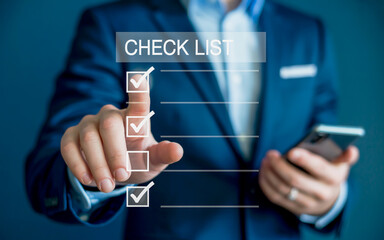 Fototapeta premium Businessman s hand interacting with a digital checklist interface marking tasks complete on a virtual screen