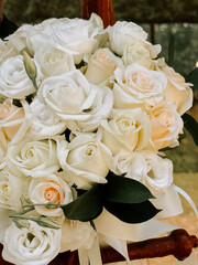 Elegant white rose bouquet for a wedding ceremony in a serene garden setting
