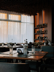Elegant dining area with natural light and stylish decor in modern restaurant setting