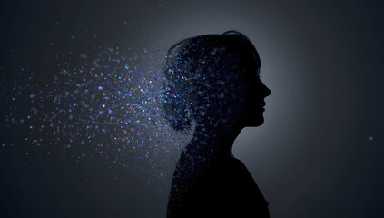 Silhouette of woman dissolving into glowing particles on dark background