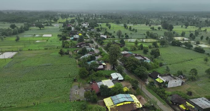 Aerial view of a village surrounded by agricultural fields near the Bhopal-Nagpur highway in Madhya Pradesh during the monsoon season.