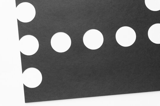 black paper with circle cutouts