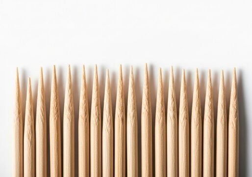 Many wooden toothpicks in a row isolated on white background
