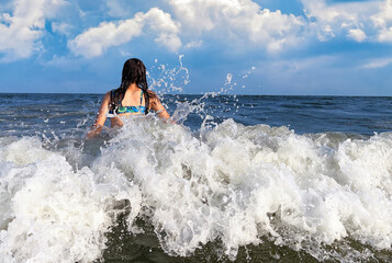 Happy teenager enjoying the ocean waves © vlad_g