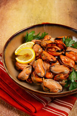 mussels no shell, boiled, mussels, peeled, in a bowl, with lemon and parsley, Chilean mussels, top view, no people,