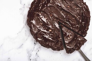 chocolate cake, round cake, on a marble light table, top view, homemade cakes, no people,