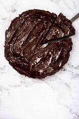chocolate cake, round cake, on a marble light table, top view, homemade cakes, no people,