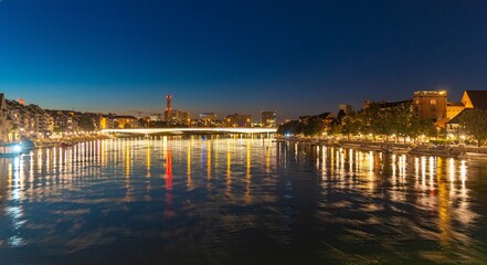 A night, long exposure, panorama of the Rhine river in Basel with the city lights