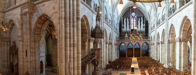 Wide angle, panoramic view of the interior of the Basel Cathedral (Munster), built between the years 1019 and 1500 in the Romantic and Gothic styles.