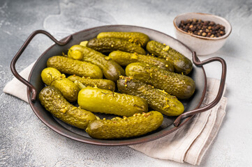 Freshly jarred dill pickles, a delightful addition to any meal or charcuterie board that adds a zesty crunch. grey background. top view