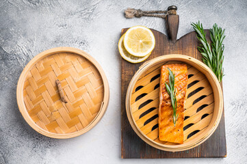 Cooked salmon fillet steak with rosemary, red sea fish. white background. top view