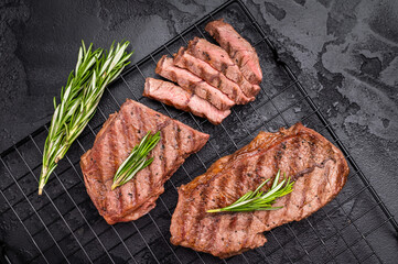 Grilled Top blade steak, shoulder beef meat. black background. top view