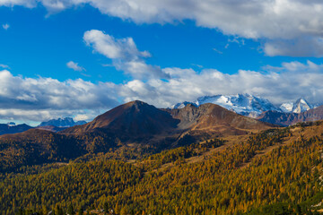 Autumn view of the Passo Giau valley in the Italian Dolomites and the snow-capped Marmolada glacier