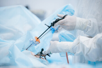 Medical team performing laparoscopic surgery with precision instruments