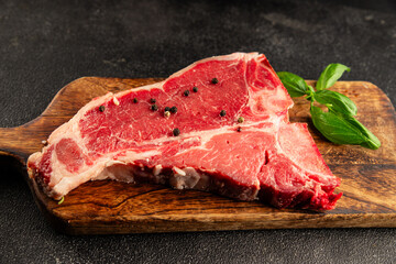 Raw steak T-bone fresh meat premium beef snack fresh delicious gourmet food background on the table rustic food top view copy space