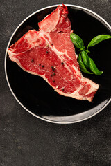 Raw steak T-bone fresh meat premium beef snack fresh delicious gourmet food background on the table rustic food top view copy space