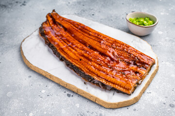 Unagi eel, Japanese grilled fish fillet of eel with sauce. grey background. top view