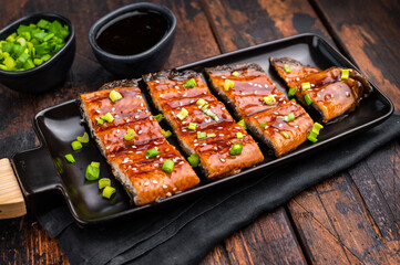 Japanese grilled eel with sweet soy sauce . wooden background. top view