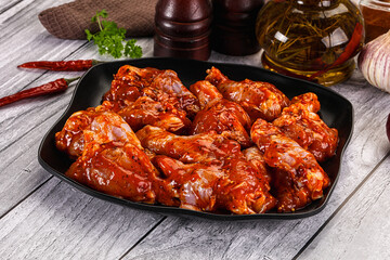 Raw marinated buffalo chicken wings