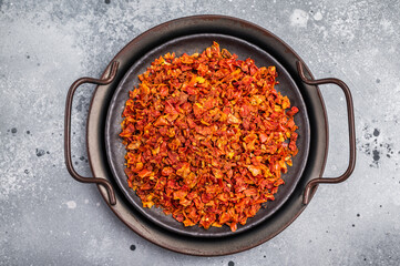 Dried Tomato Flakes, Indian and Arabic spices for cooking. grey background. top view