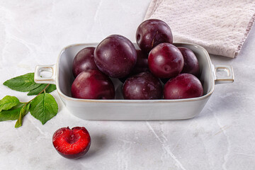 Raw ripe purple plum heap