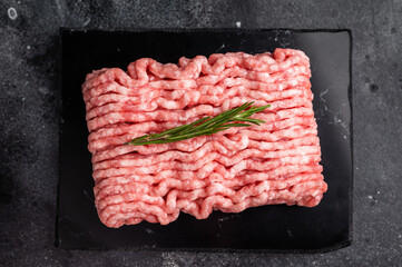 Raw ground pork meat, mincemeat. black background. top view