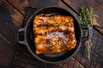 Teriyaki salmon fish fillet with glaze in a skillet. wooden background. top view