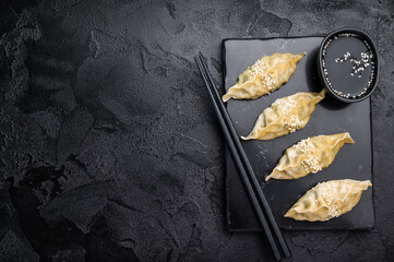 Steamed Japanese Gyoza Dumplings with meat and vegetables. black background. top view