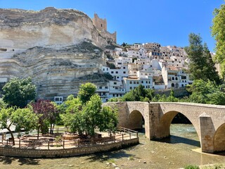 Panoramic view of Alcala del Jucar with historic bridge and cliffside white houses. Charming Spanish village built into the cliffs of a dramatic canyon, Castilla-La Mancha, Spain. 25 May 2025