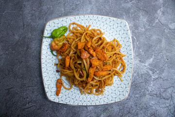 Naga Chicken Chowmein in plate Spicy Noodles with Chicken and Hot Peppers top view of Chinese food
