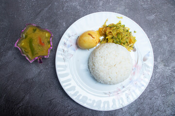 Indian style Meal with Lentil Curry Dal, Rice, and Boiled Egg in plate top view of South Asian cuisine