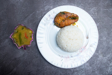 Pakistani Fish Curry Meal with Rice and Lentils in plate top view of South Asian cuisine