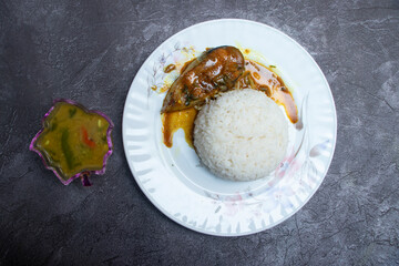 Bengali Fish Curry with White Rice and Vegetable Side Dish in plate top view of Asian cuisine