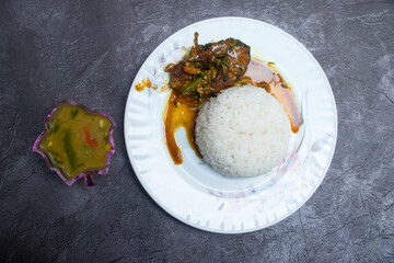 Indian Thali Set Menu with Chicken Curry, Basmati Rice, and Assorted Dishes in plate top view of Indian cuisine