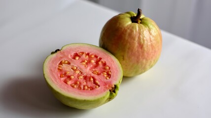 Fresh pink guava cut in half with whole fruit tropical
