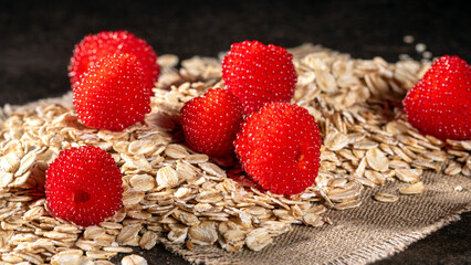 A colorful display of tibetan raspberries with oatmeal flakes for healthy meals