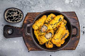 Korean Crispy seaweed noodle rolls Gimmari deep-fried seaweed rice rolls. grey background. top view