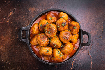 Juicy meatballs, perfectly seasoned and beautifully browned, ready to be served with marinara sauce. A classic comfort food that never disappoints. brown background. top view